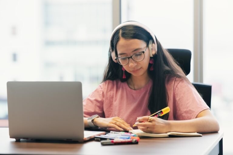 Student studying with headphones representing the AIStudyMaterial platform